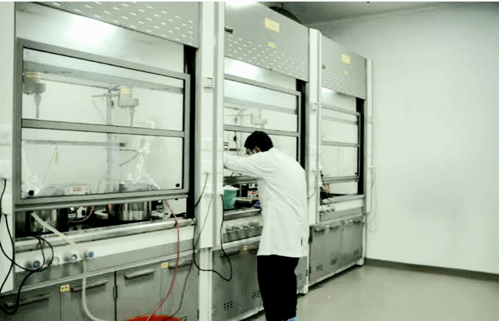 Chemist working at the fume hood in the R&D lab